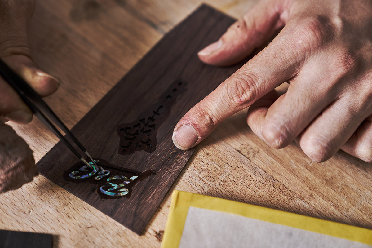 Putting in the inlays for the logo on the headstock